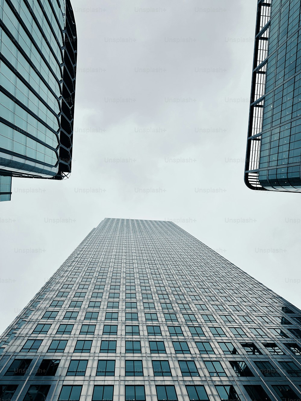 looking up at a tall skyscraper in a city