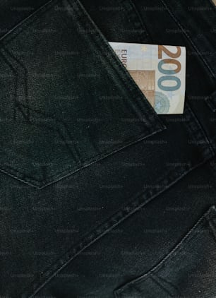 a money bill sticking out of the back pocket of a pair of jeans