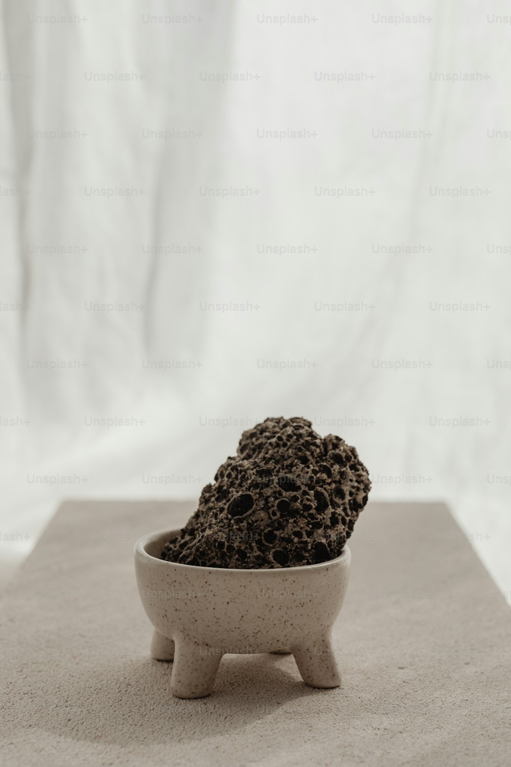 a bowl of dirt sitting on top of a table