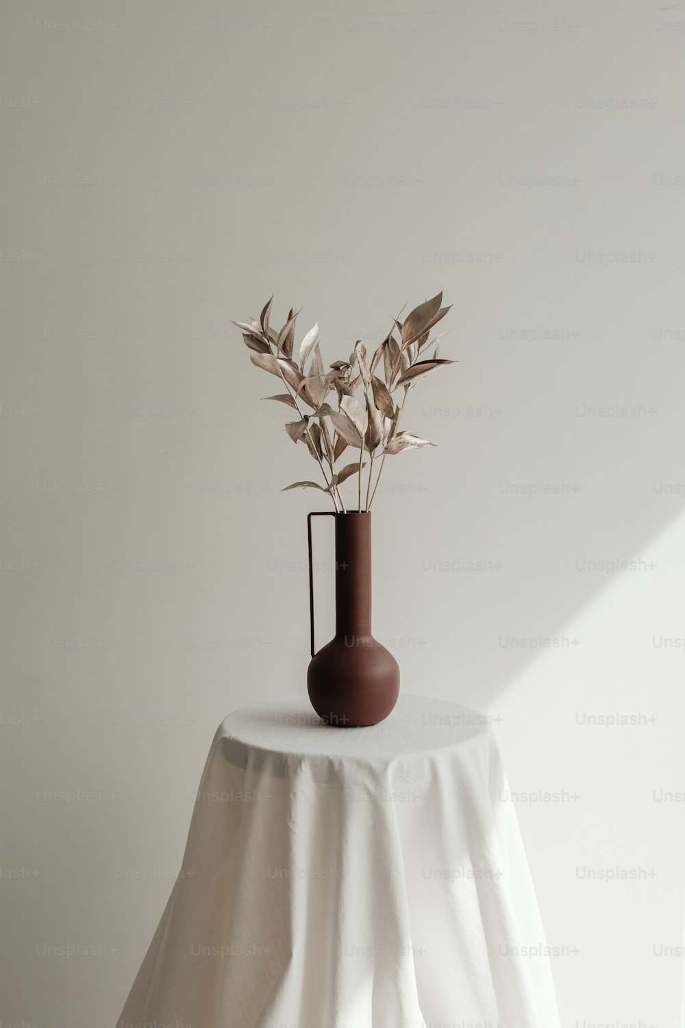 un vase avec une plante dedans assis sur une table