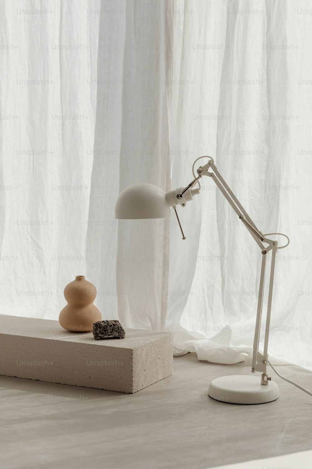 a table with a lamp and a rock on it