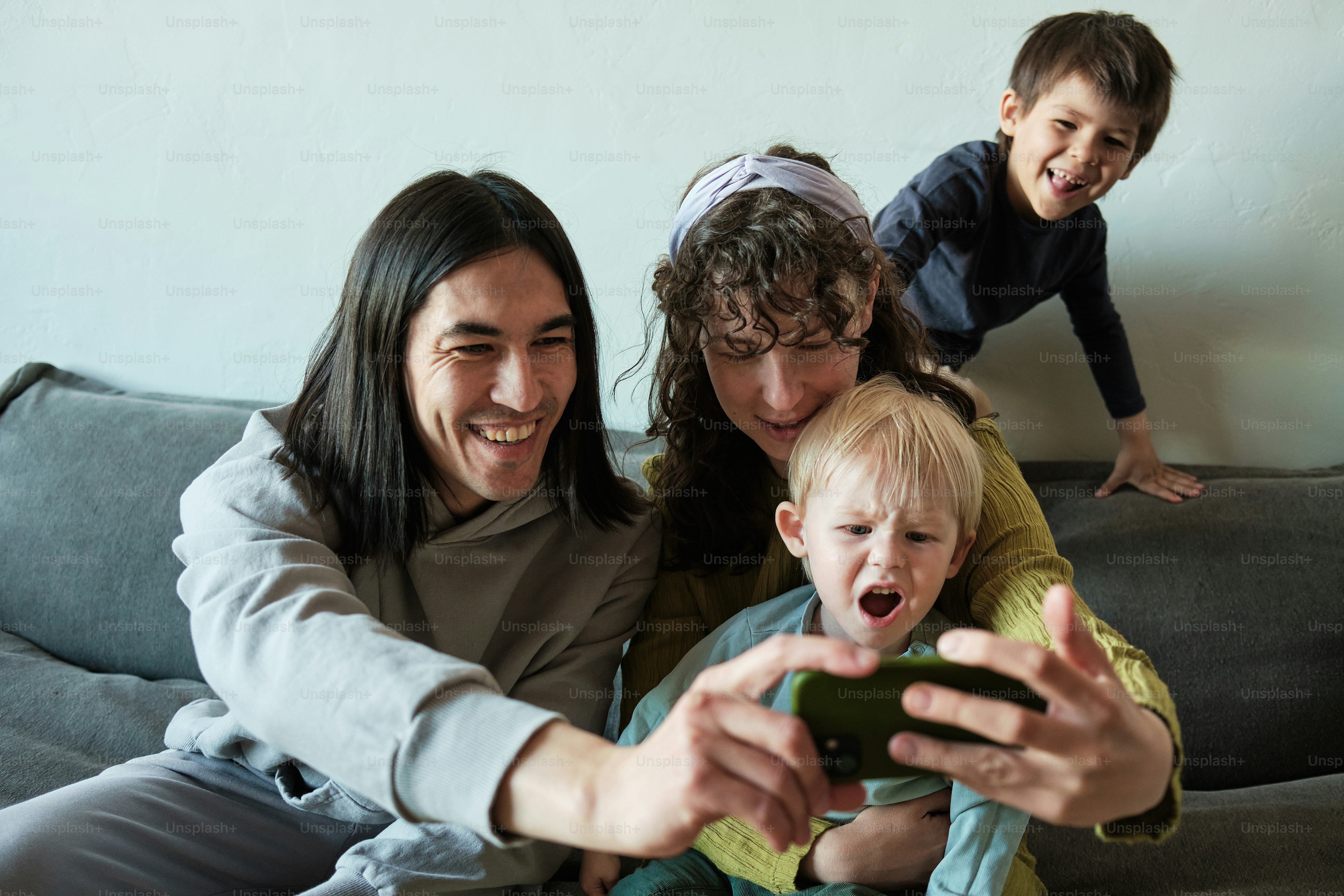 a man, woman, and child sitting on a couch
