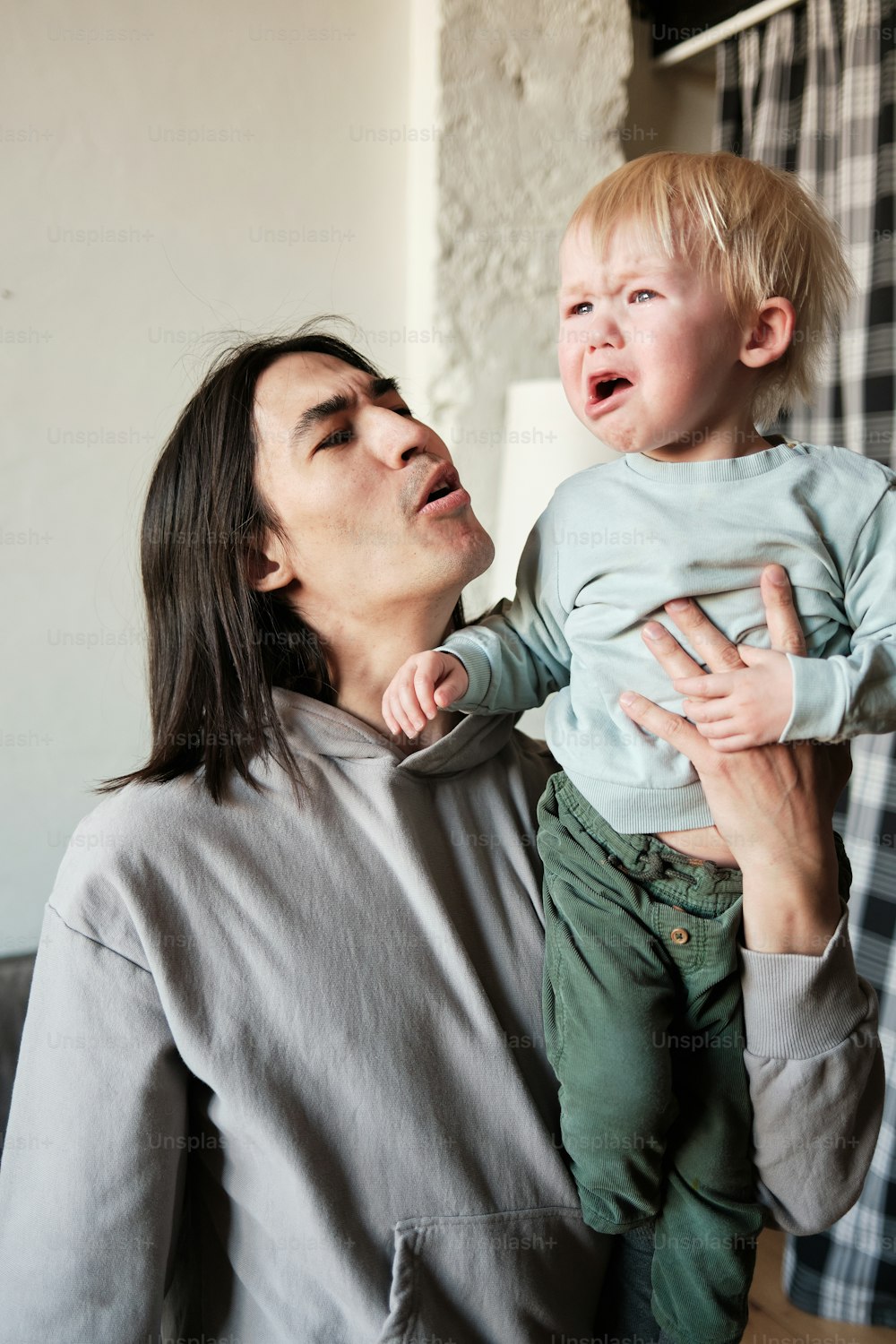 a woman holding a small child in her arms