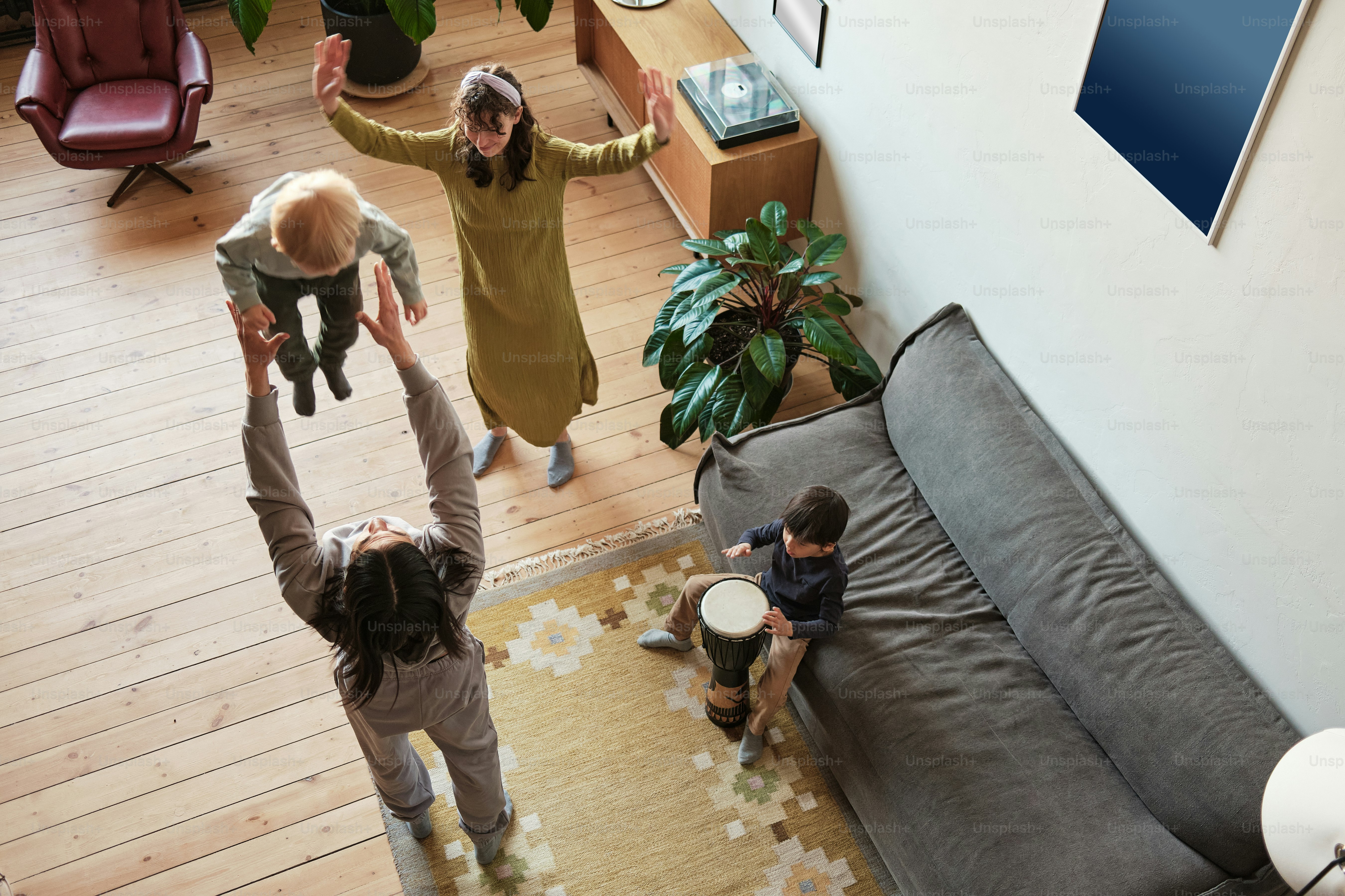 family dances while his son drums on djembe