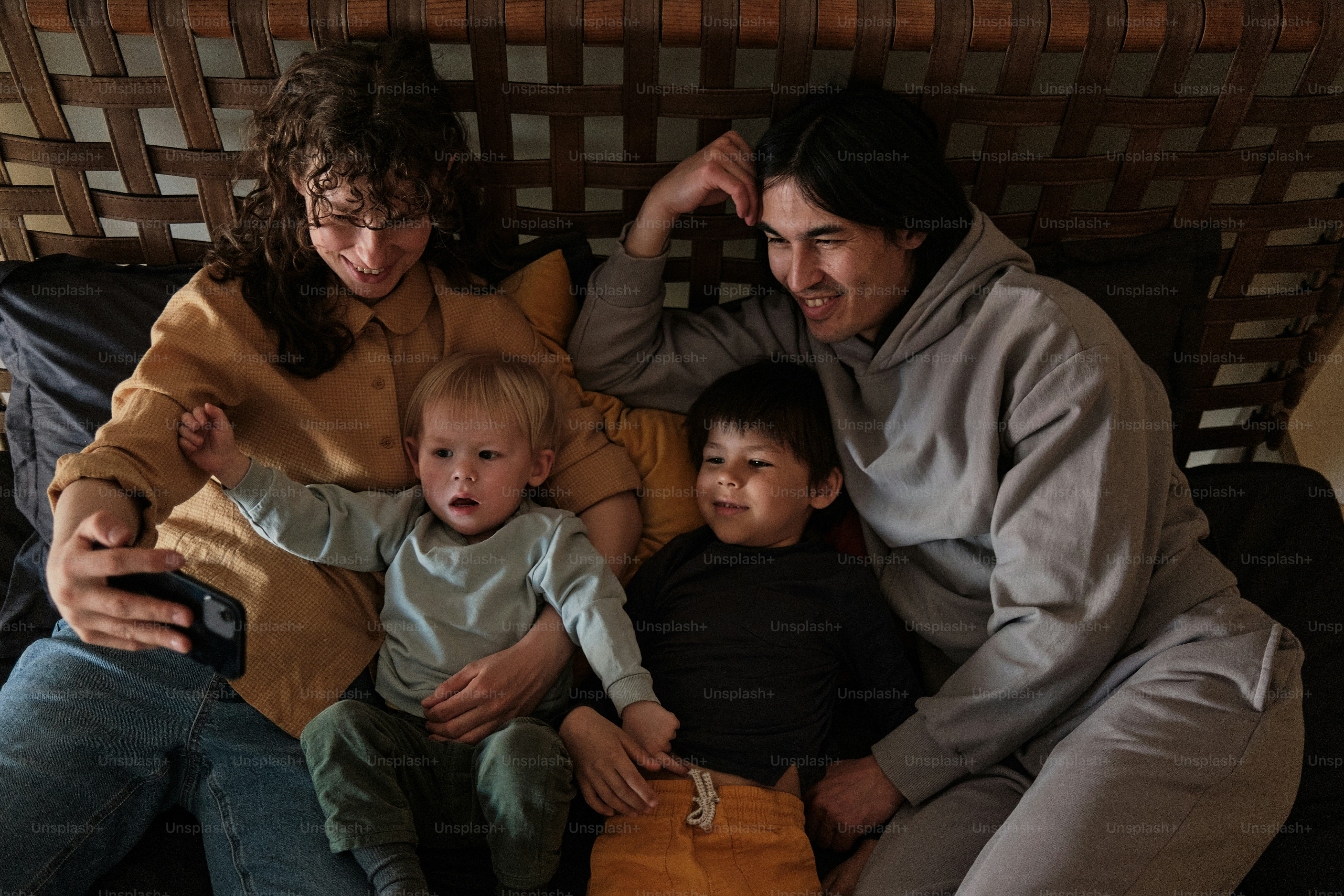a group of people sitting on top of a bed