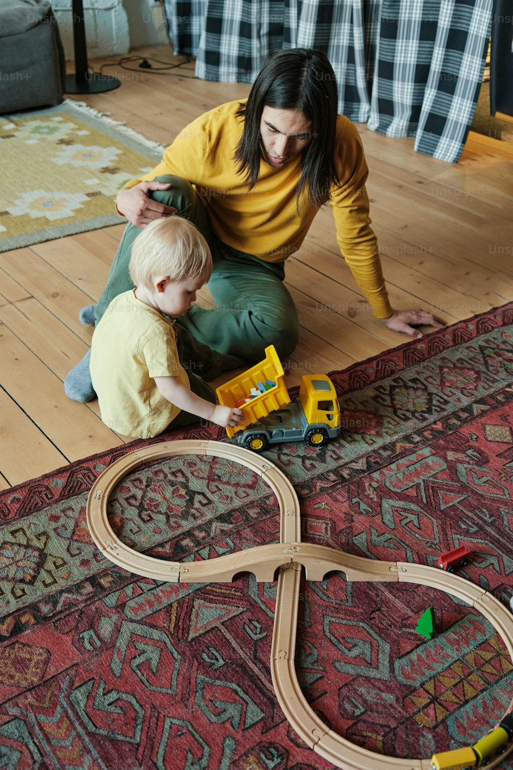 a woman playing with a child on the floor