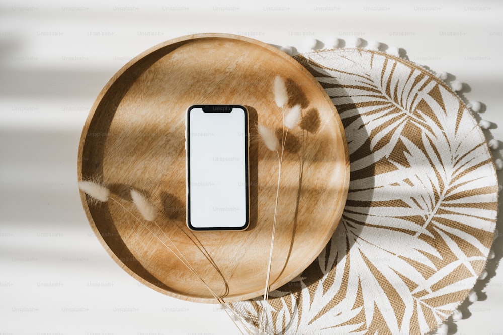 a cell phone sitting on top of a wooden plate