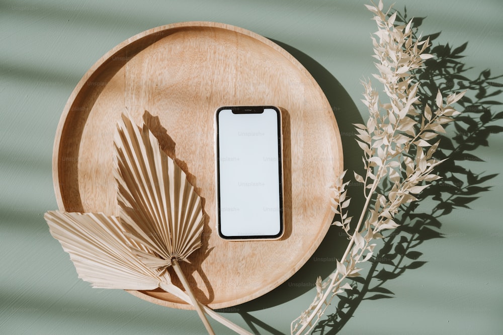 a cell phone sitting on top of a wooden plate