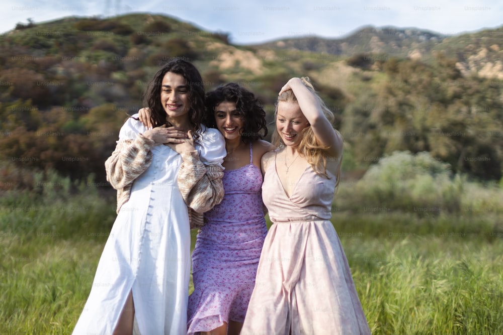 a group of three women standing next to each other