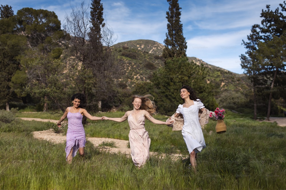 a group of women walking across a lush green field