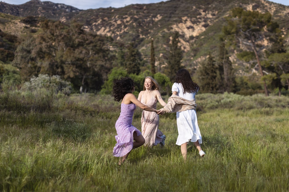 a group of women in a field holding hands