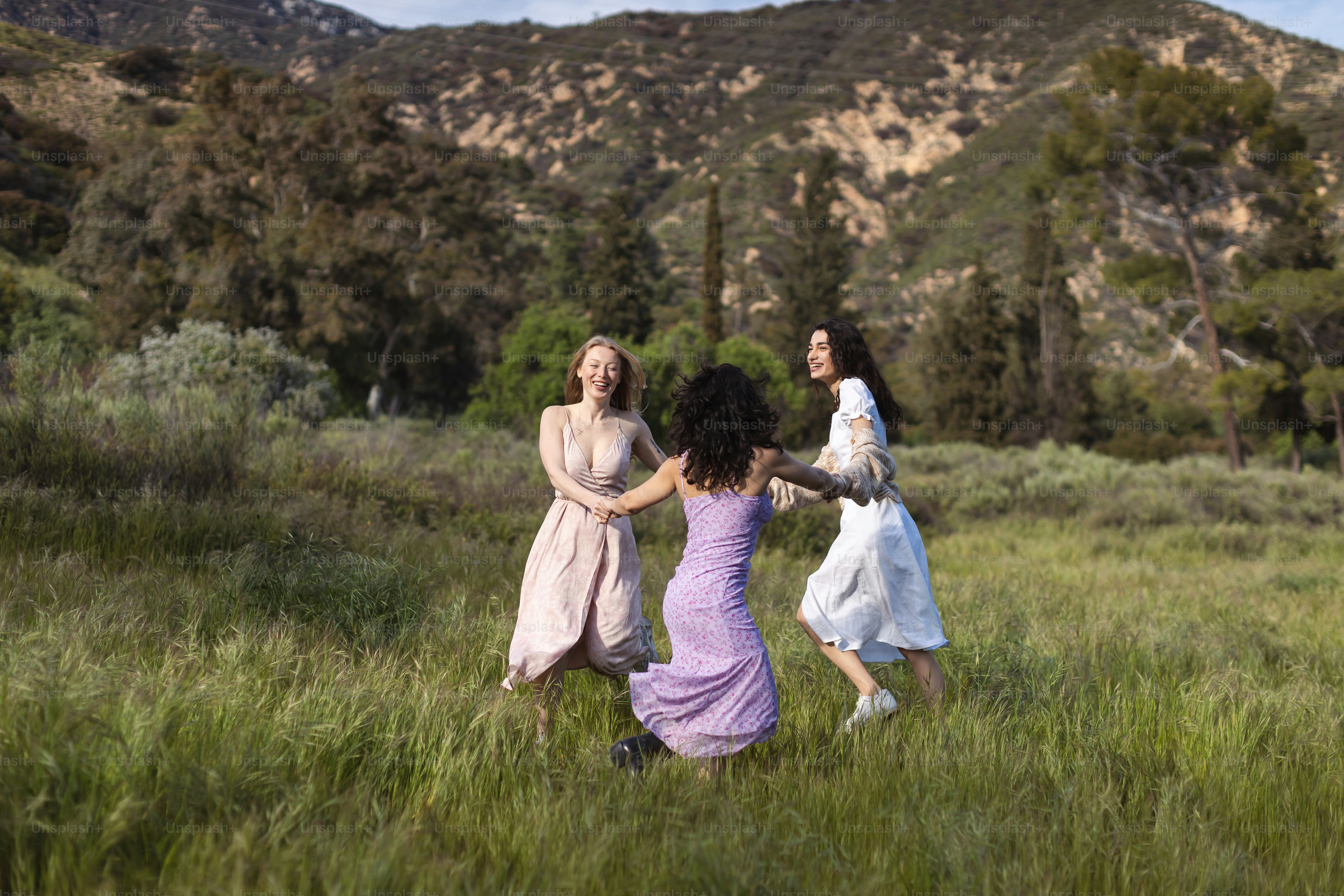 a group of women playing a game of frisbee in a field