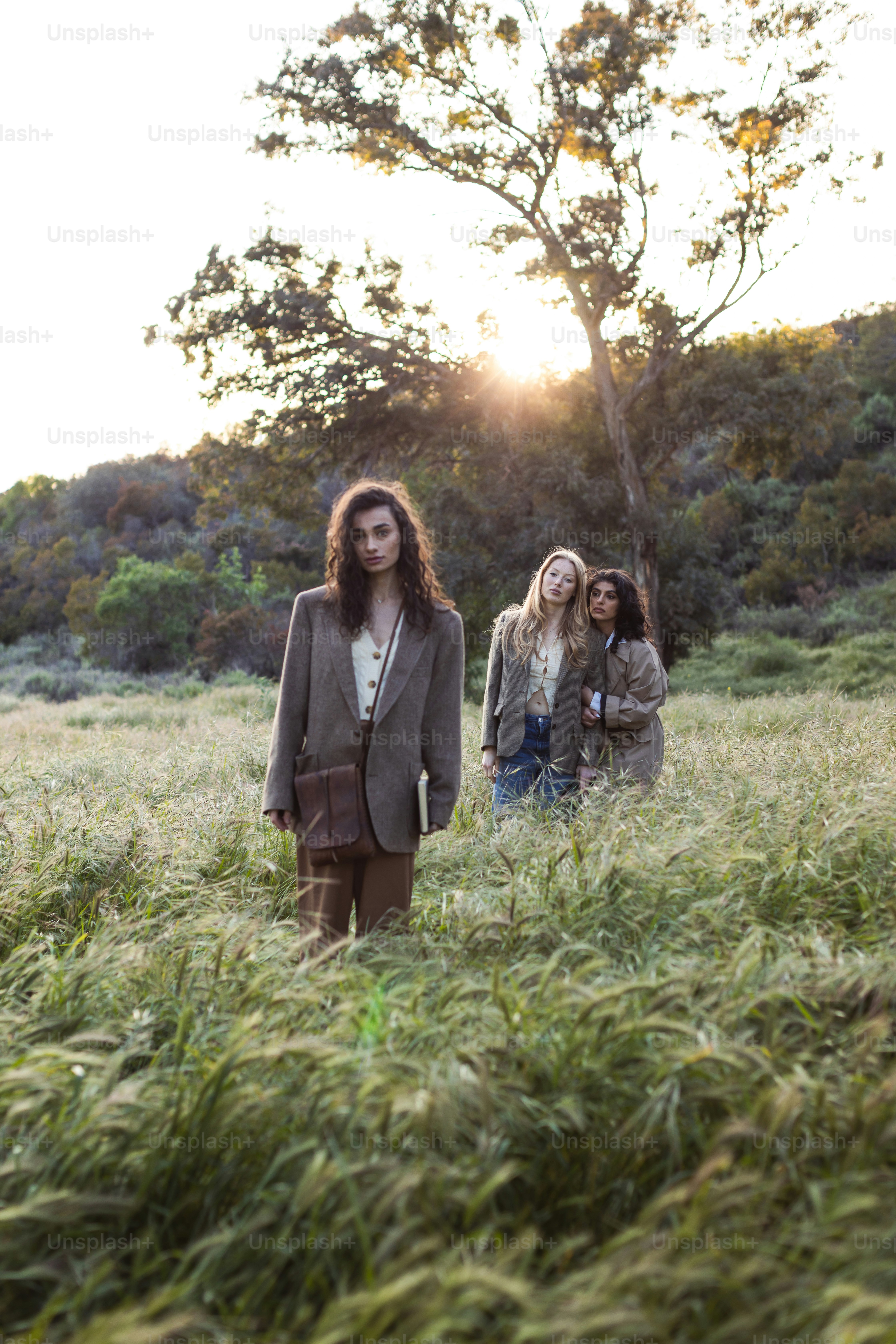 a group of people standing in a field of tall grass