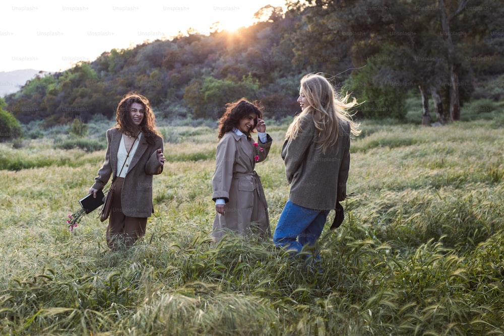 a group of women standing in a field of tall grass