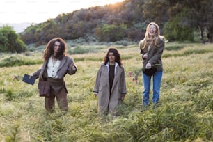 a group of people standing in a field of tall grass