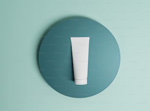 a tube of cream sitting on top of a blue circle
