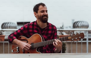 a man with a beard playing a guitar