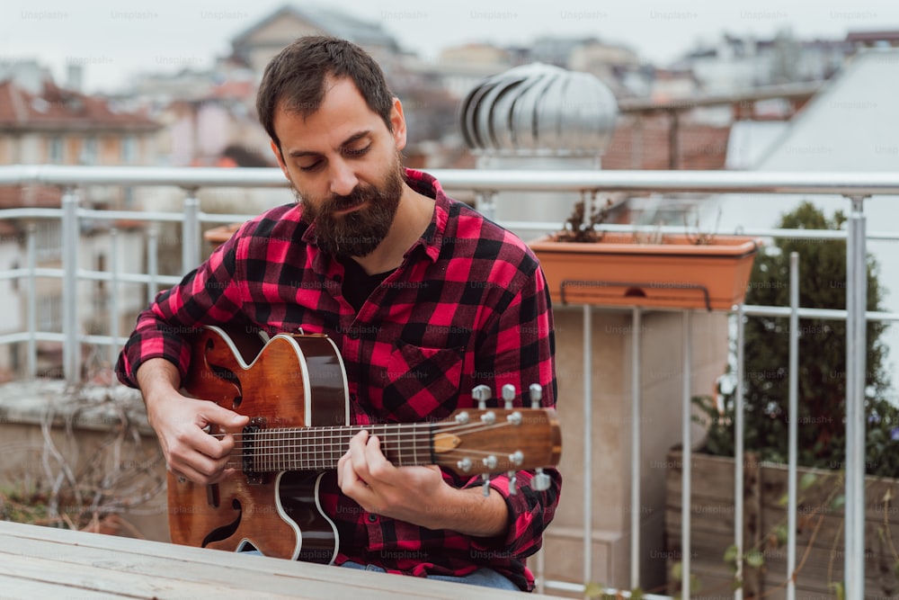 a man with a beard playing a guitar