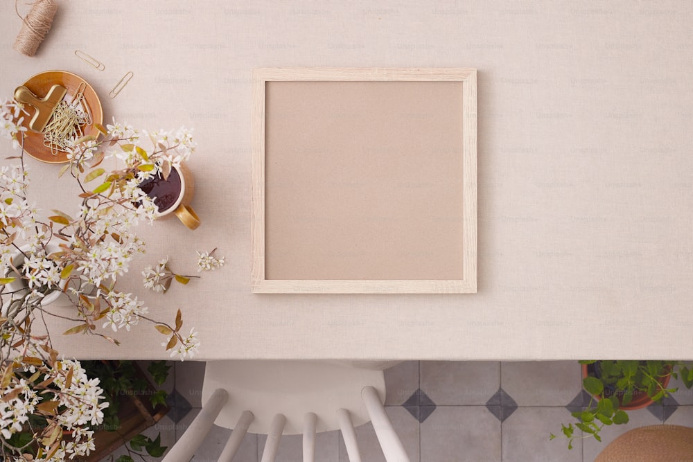 a picture frame sitting on top of a table next to a vase of flowers