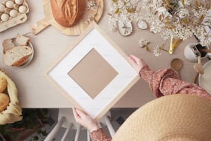 a person holding a picture frame in front of a table full of food