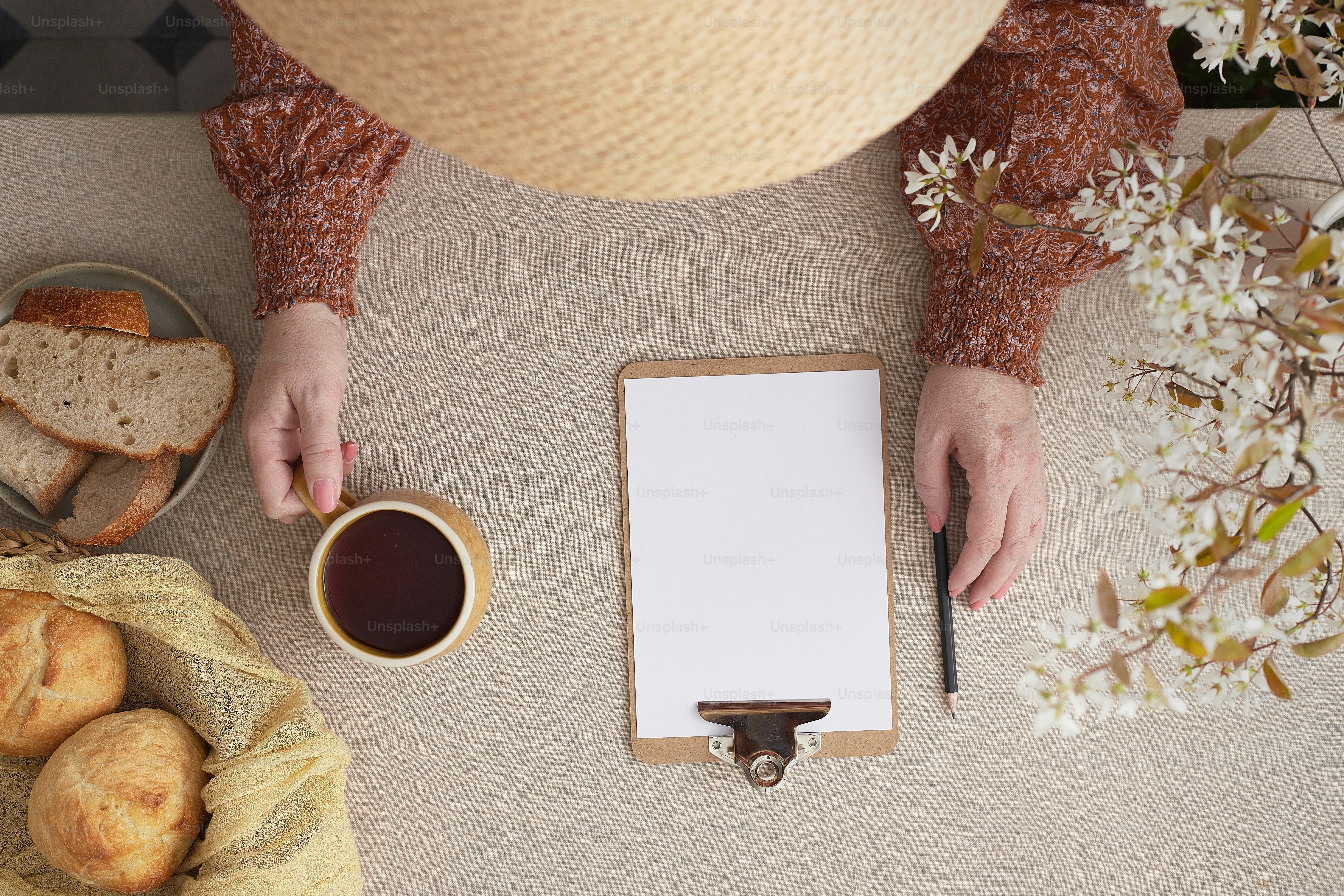 una persona sosteniendo una taza de café junto a una tableta