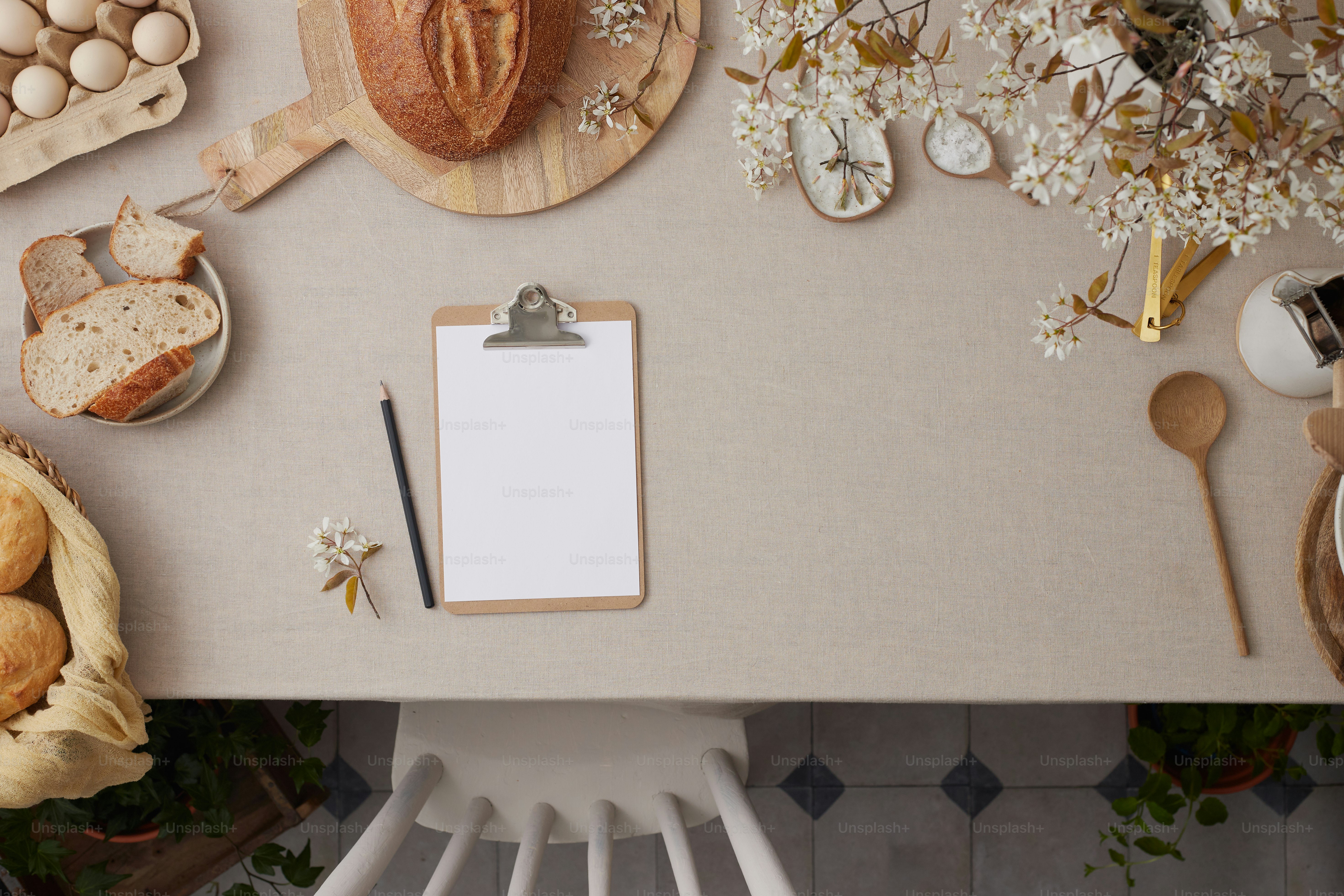 a table topped with a clipboard next to a bunch of bread