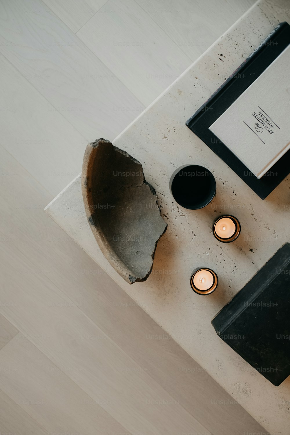 a table topped with candles and a book