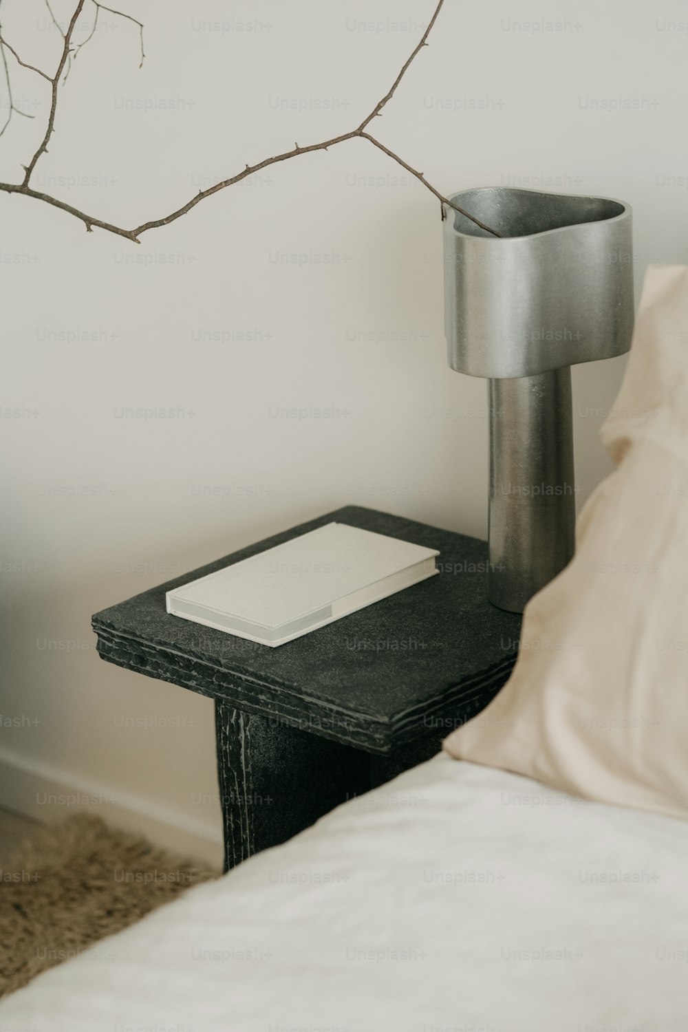a small black table with a white book on it