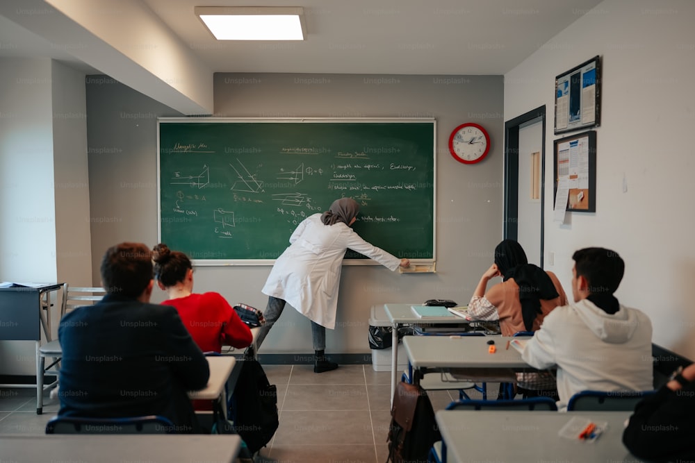 a woman in a white lab coat writing on a blackboard