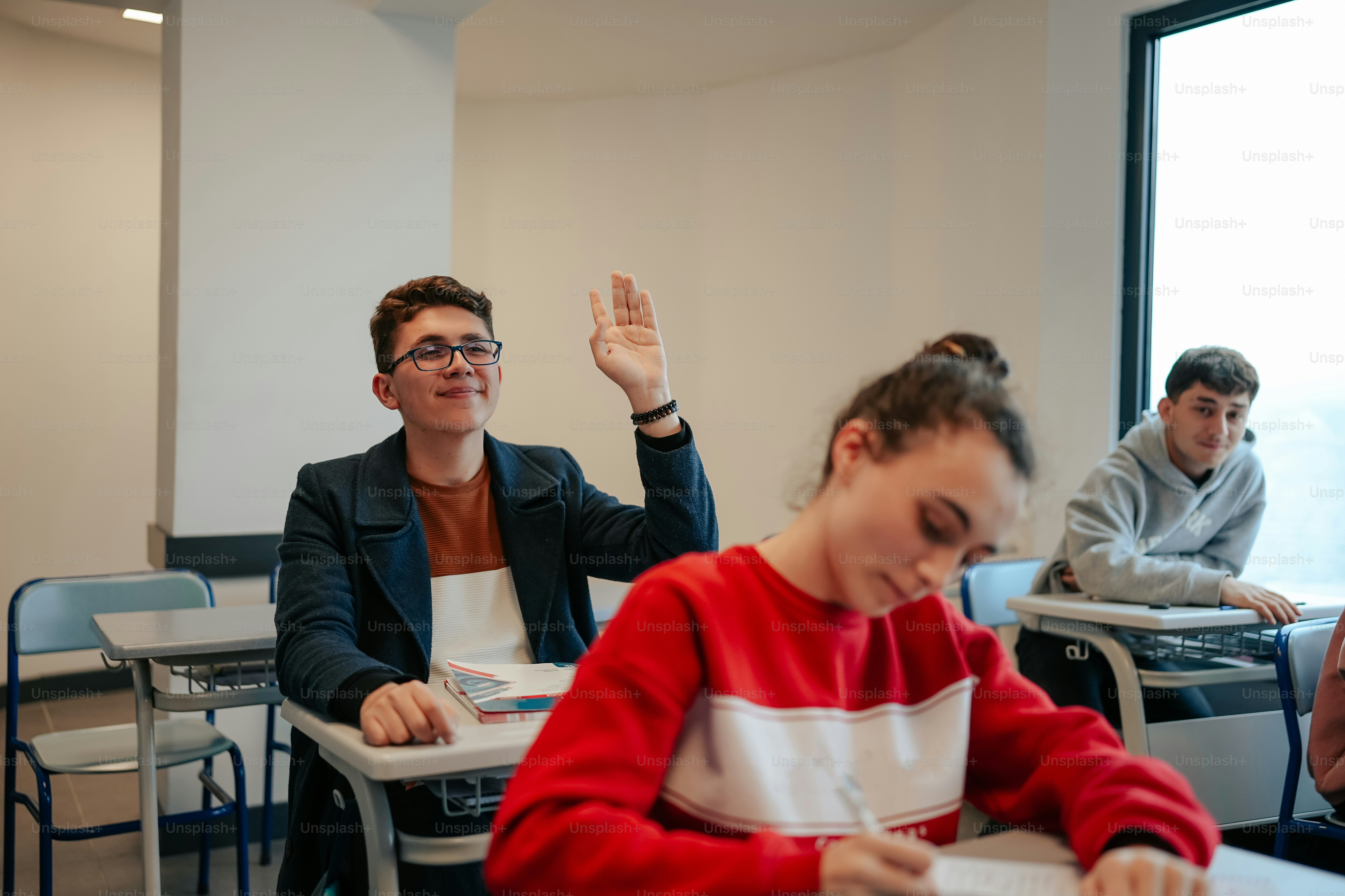 a group of people sitting at desks in a classroom