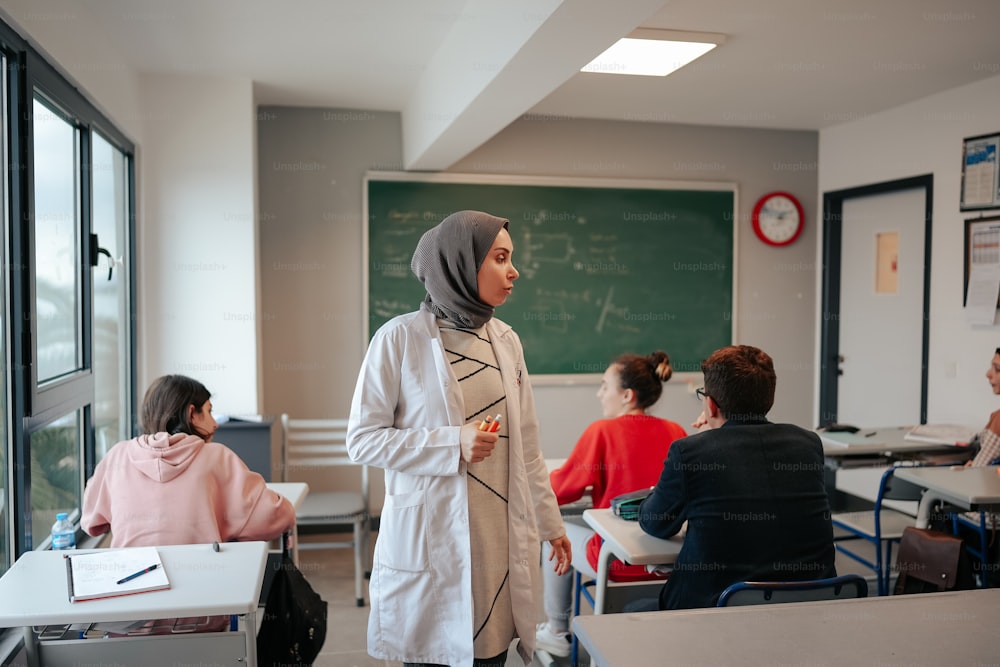 a woman standing in front of a class room
