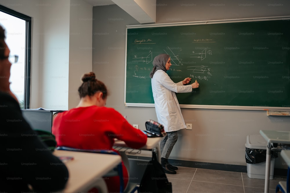 a woman standing in front of a blackboard in a classroom