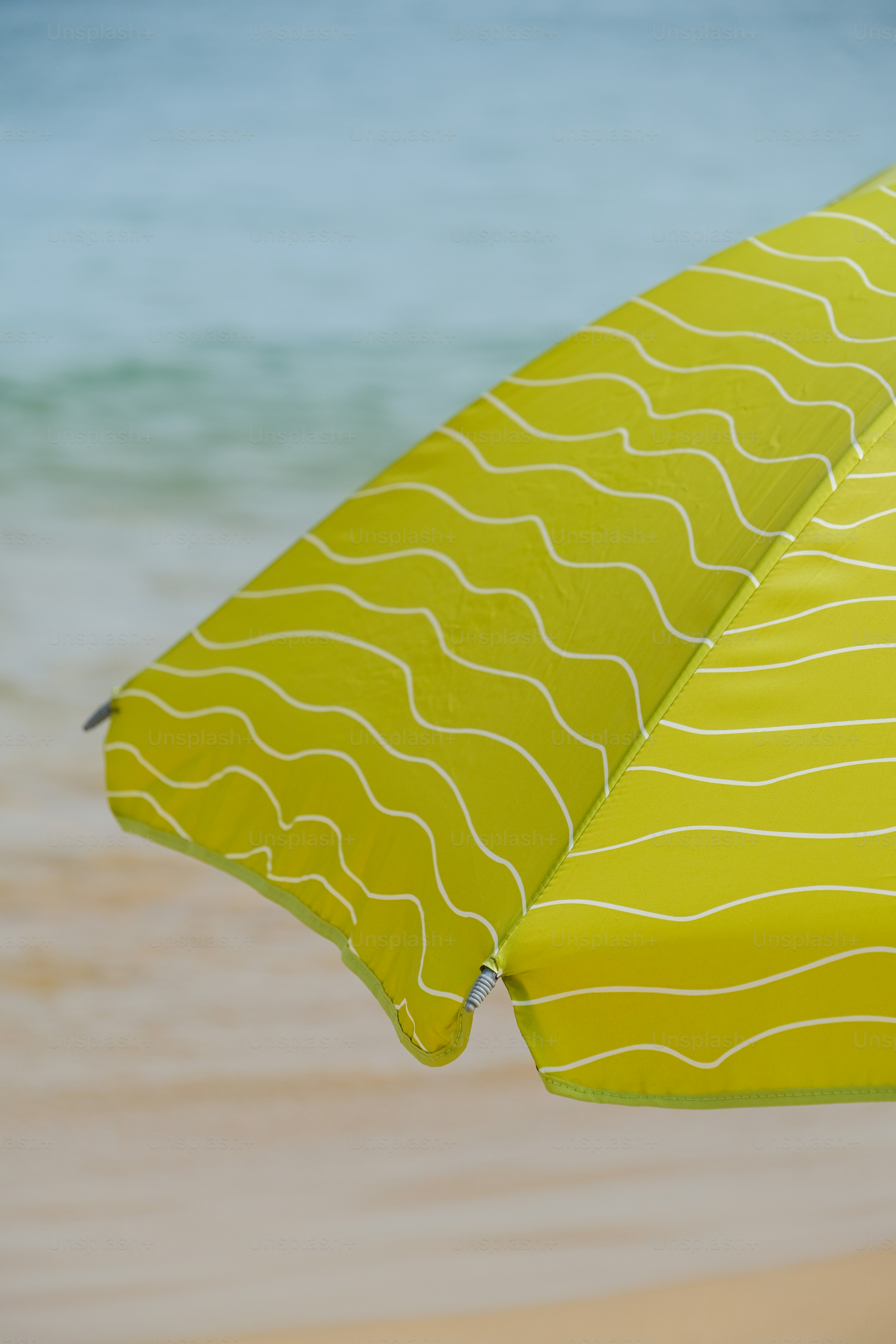a close up of an umbrella on a beach