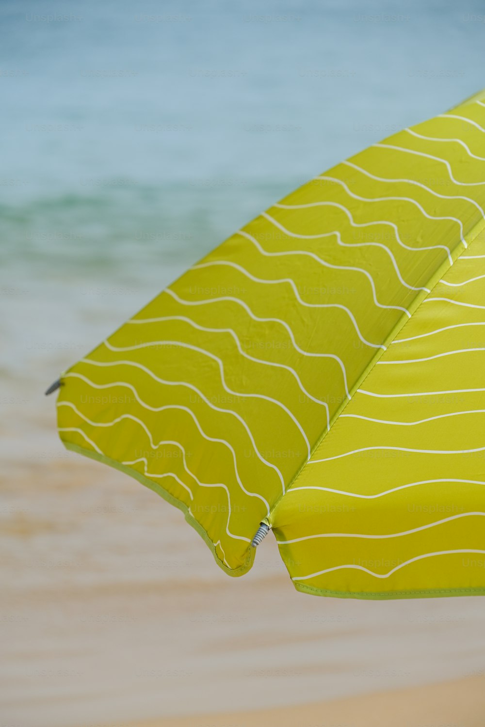 a close up of an umbrella on a beach