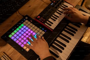 a person playing a keyboard with a multicolored keyboard