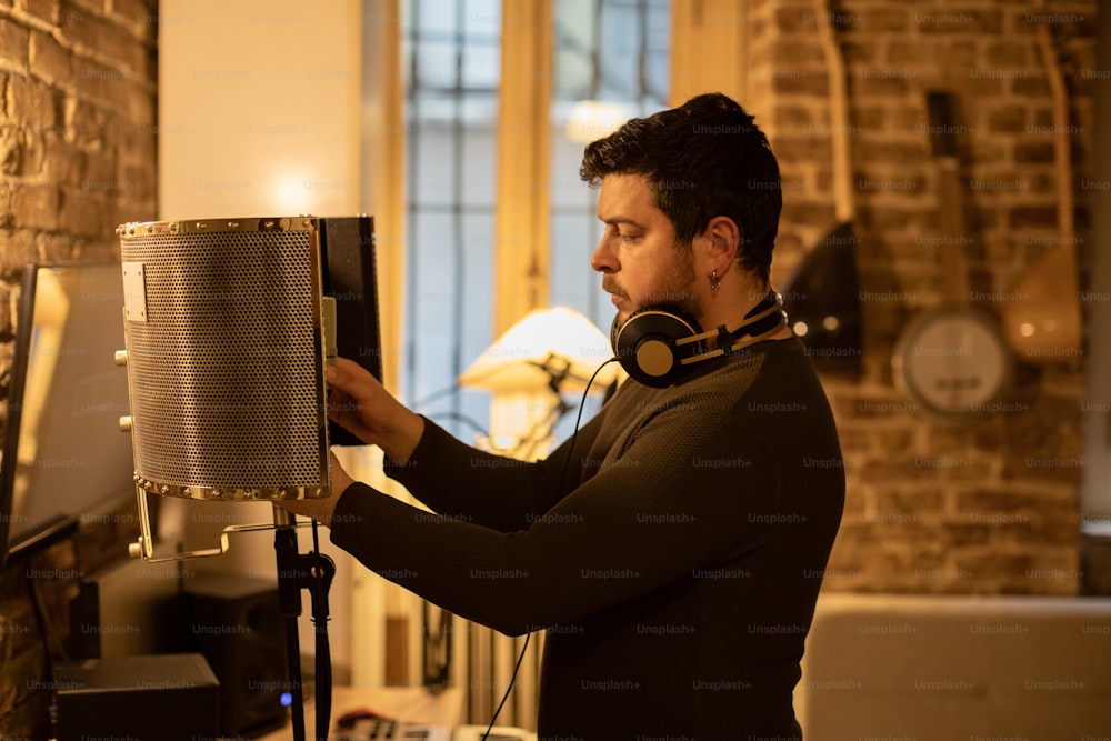 a man wearing headphones is looking at a heater