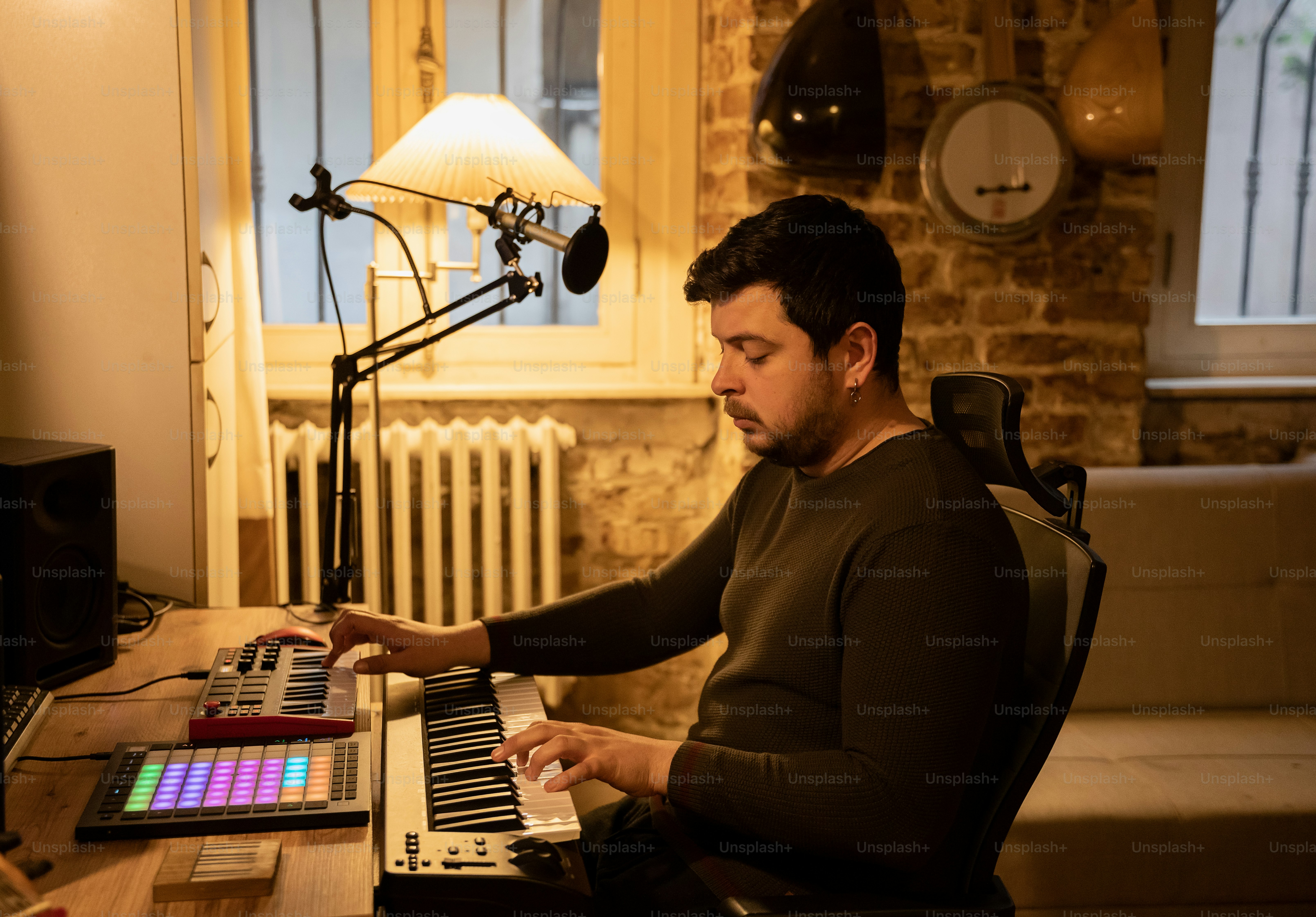 a man sitting at a desk playing a keyboard