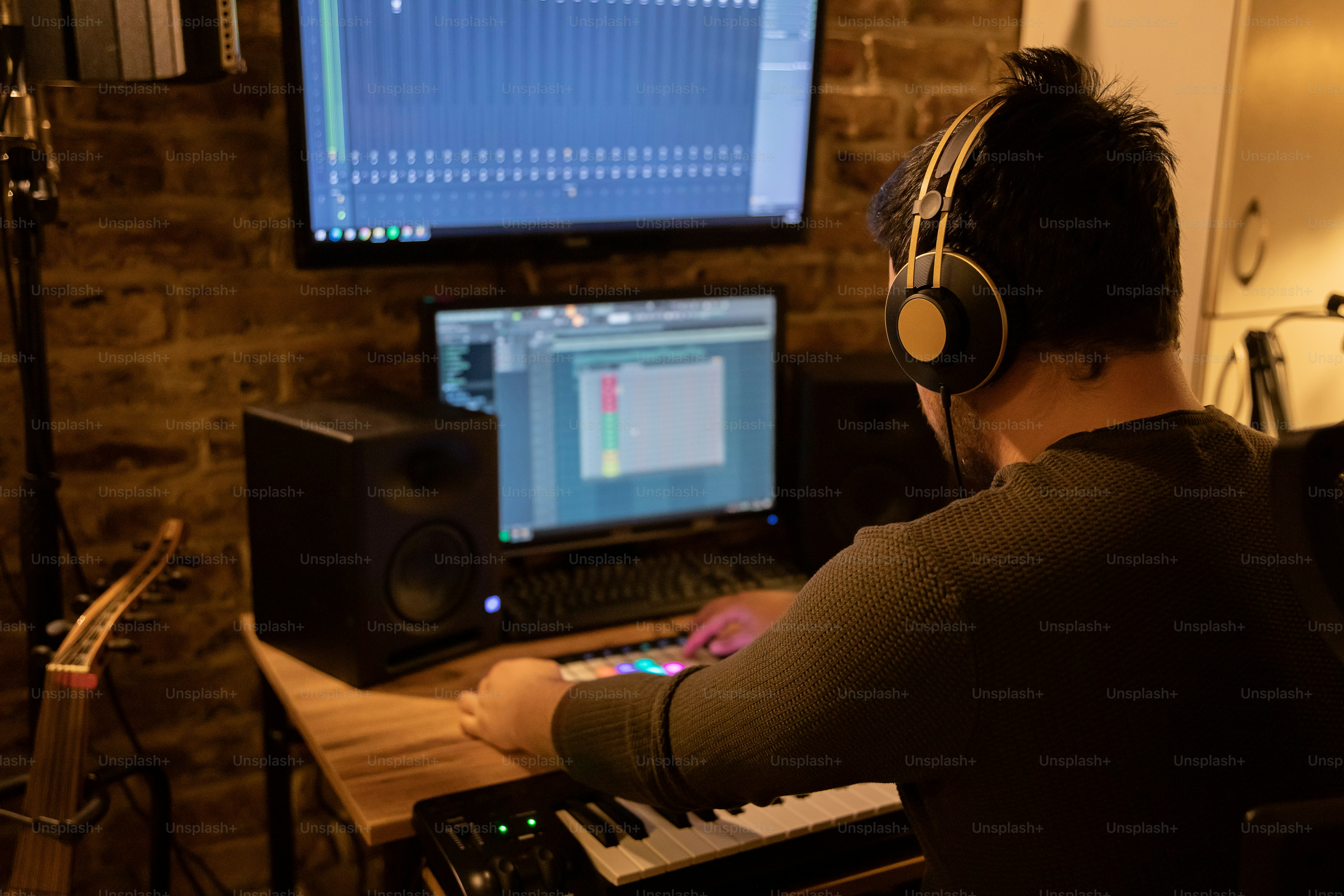 a man wearing headphones sitting in front of a computer
