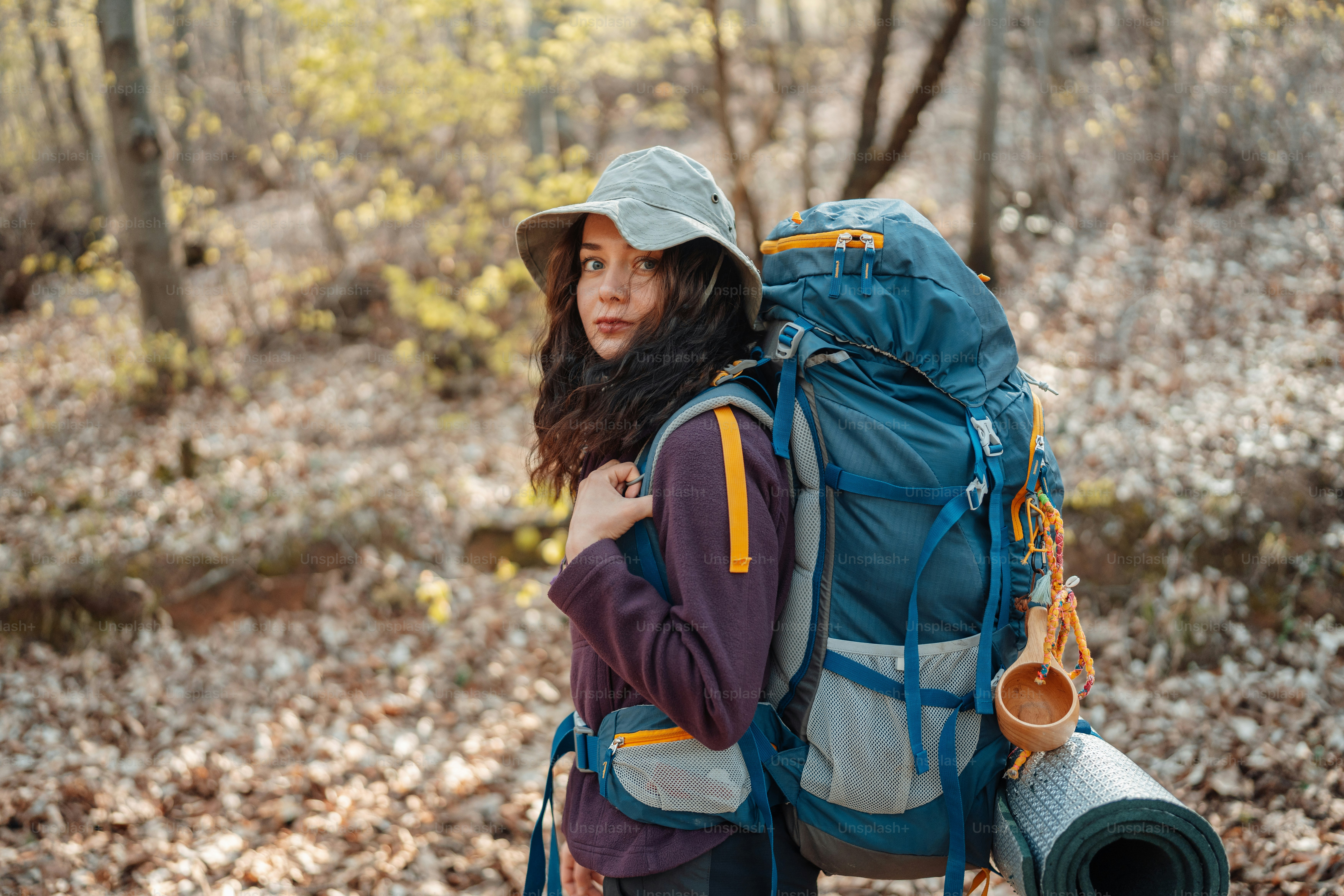 a woman with a backpack and a roll of tape