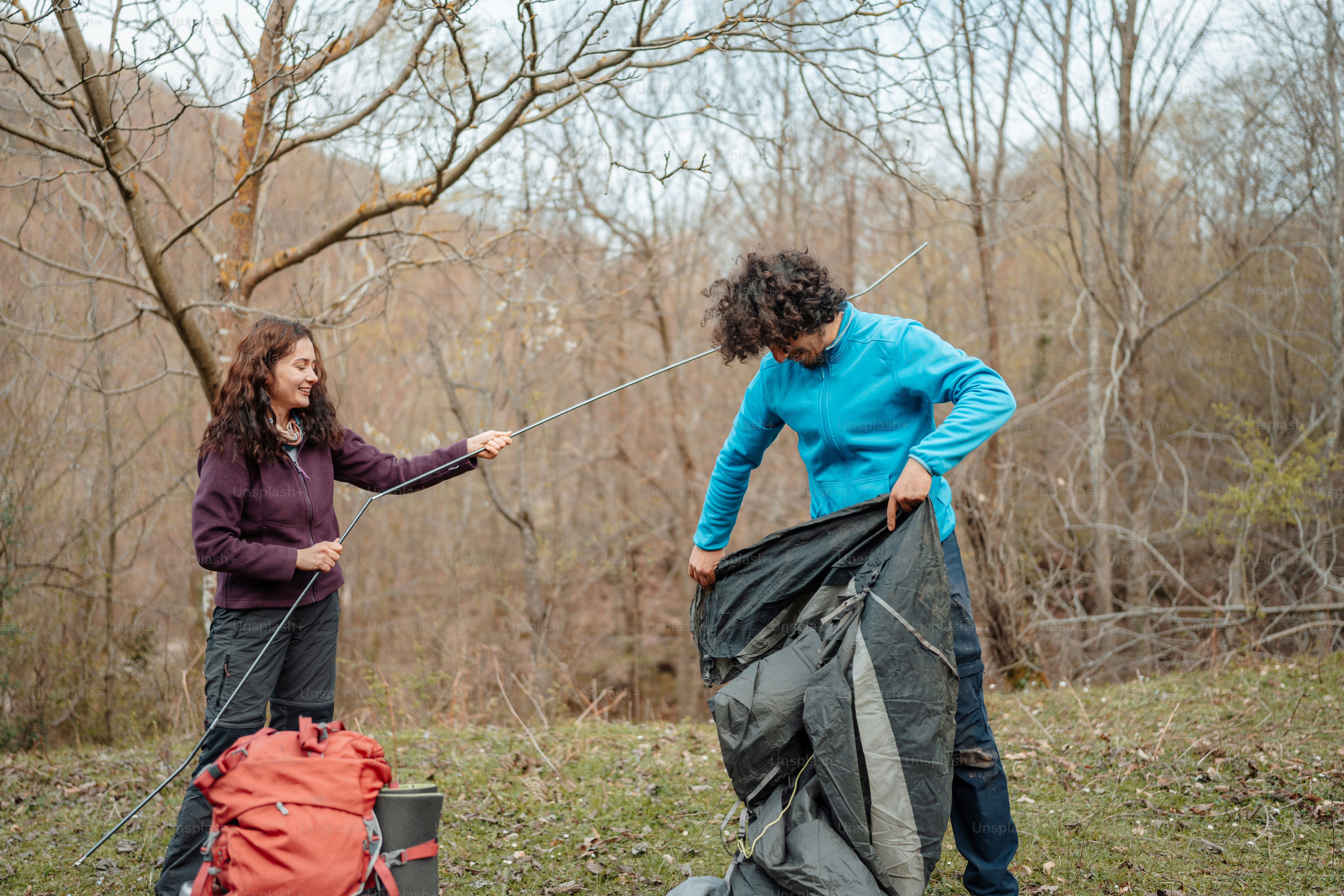 A man with a backpack is walking in the woods photo – Forest Image on ...