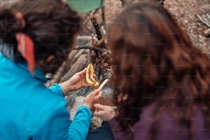 a man and a woman eating a hot dog