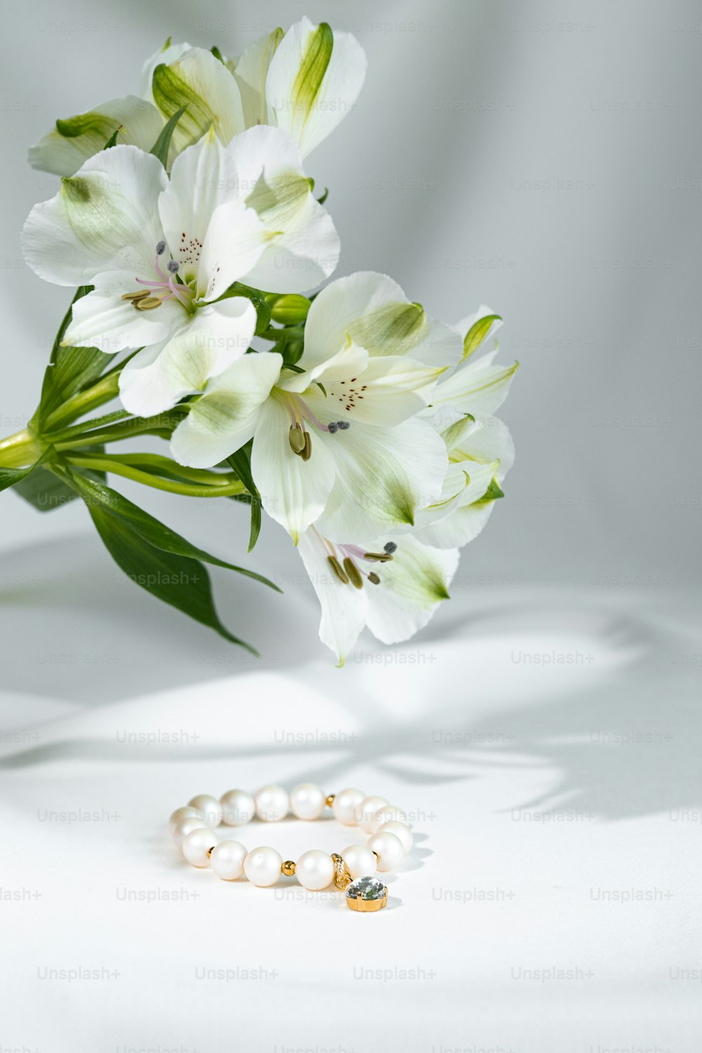 a bouquet of flowers and a pair of pearls