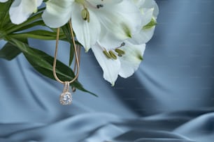 a close up of a flower with a necklace on it