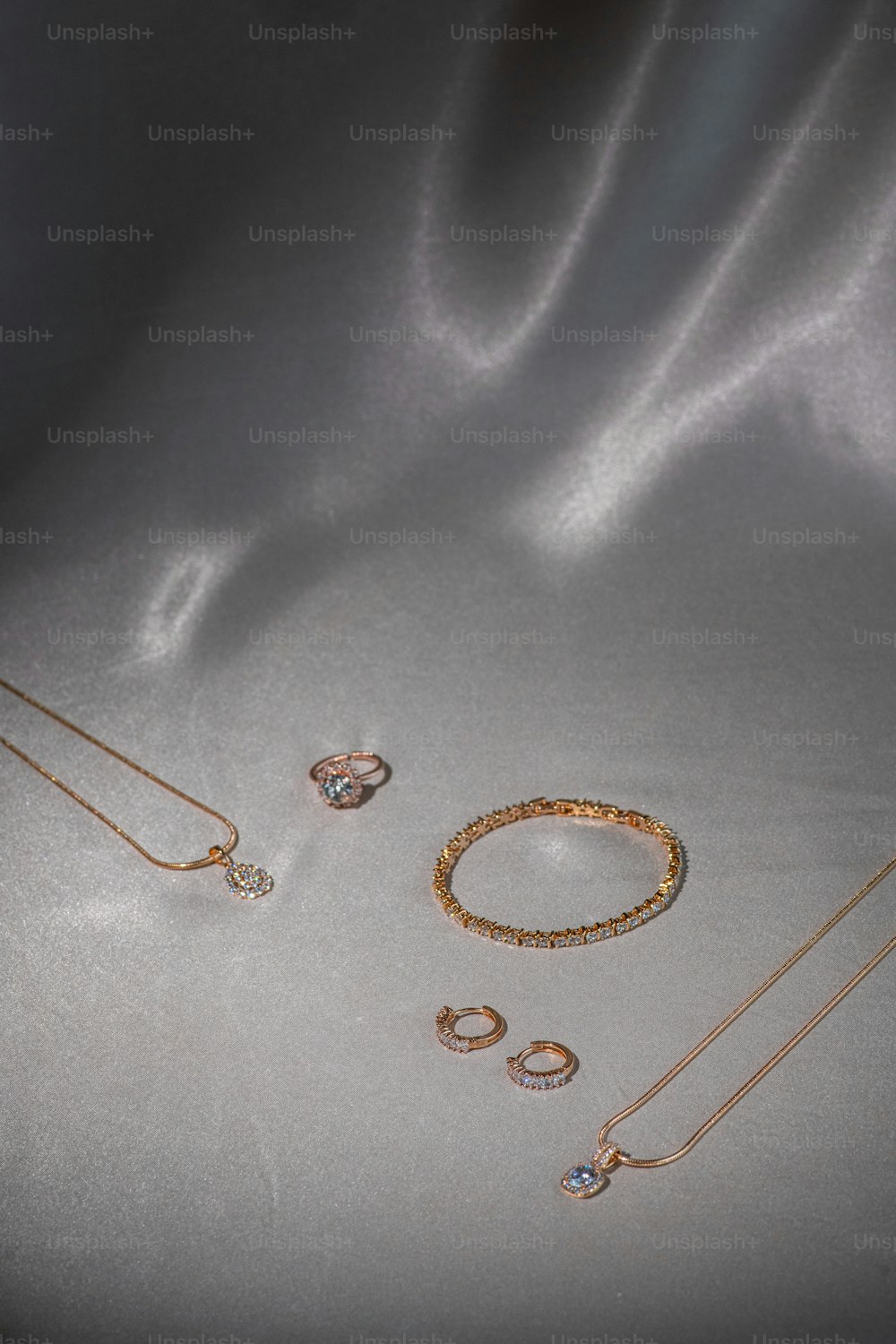 a collection of jewelry on a shiny surface