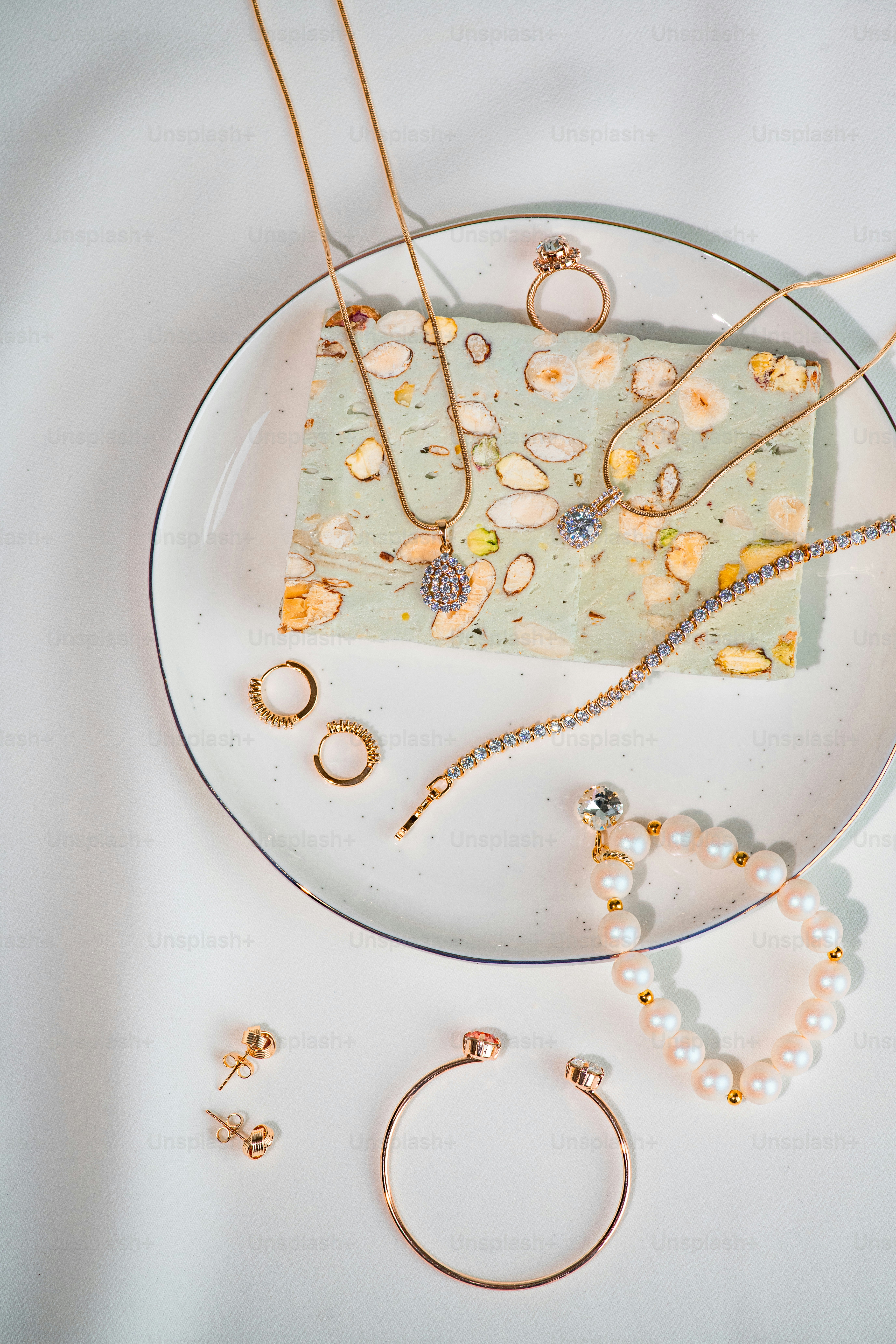 a white plate topped with lots of jewelry