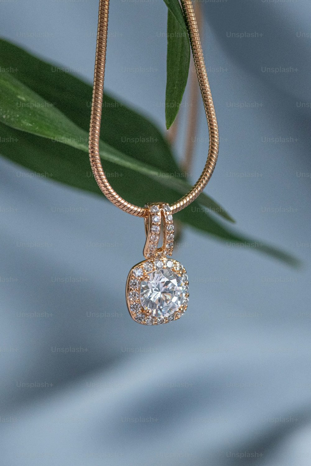 a necklace with a heart shaped diamond hanging from it