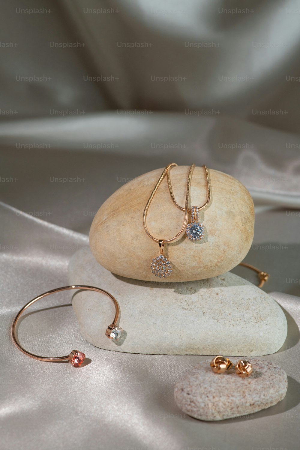 a couple of bracelets sitting on top of a rock