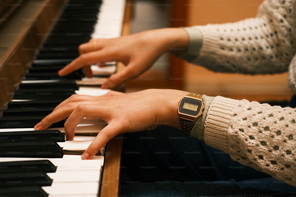 a close up of a person playing a piano