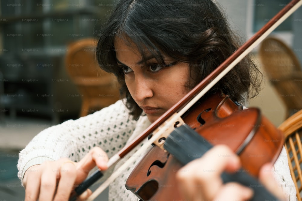 Una mujer está tocando un violín afuera