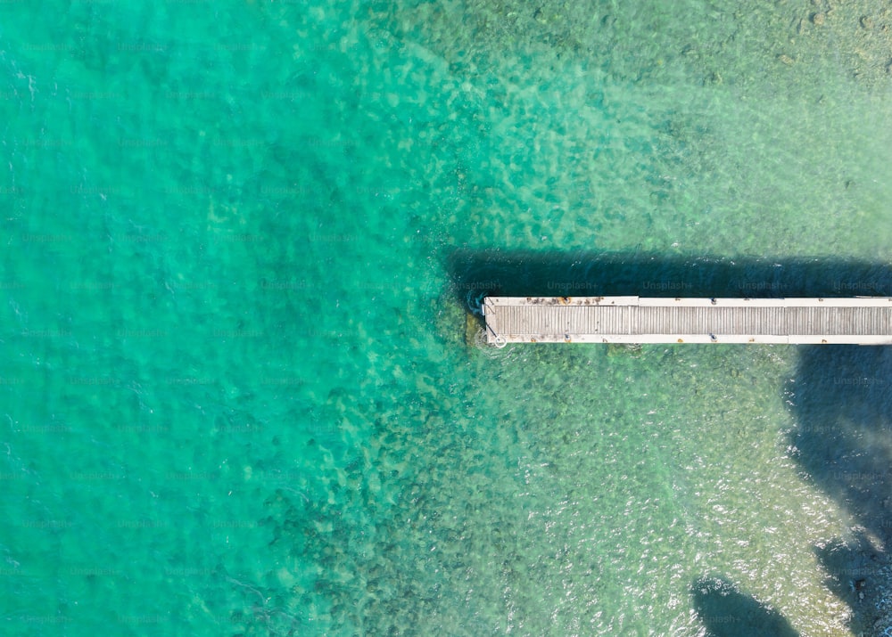 an aerial view of a pier in the ocean